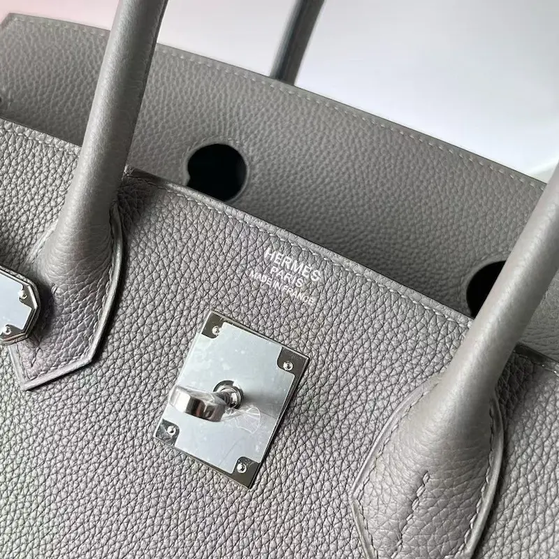 Close-up of authentic-depth Hermès Paris stamp on replica Replica Handbag Store bag