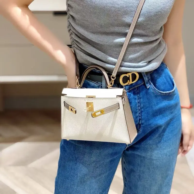 Fashion model wearing white Epsom replica Hermes Kelly 19cm with summer dress