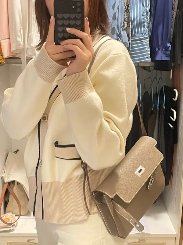 Side view of replica Hermes Kelly Depeches 25 pouch in Etoupe Grey leather