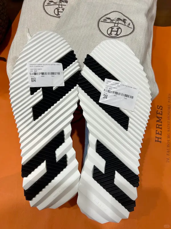 Closeup of denim replica sneaker sole with $179 price tag - gripper tread detail