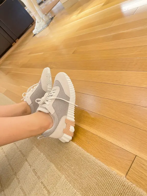 Breathable mesh Hermes replica sneakers styled with summer dress