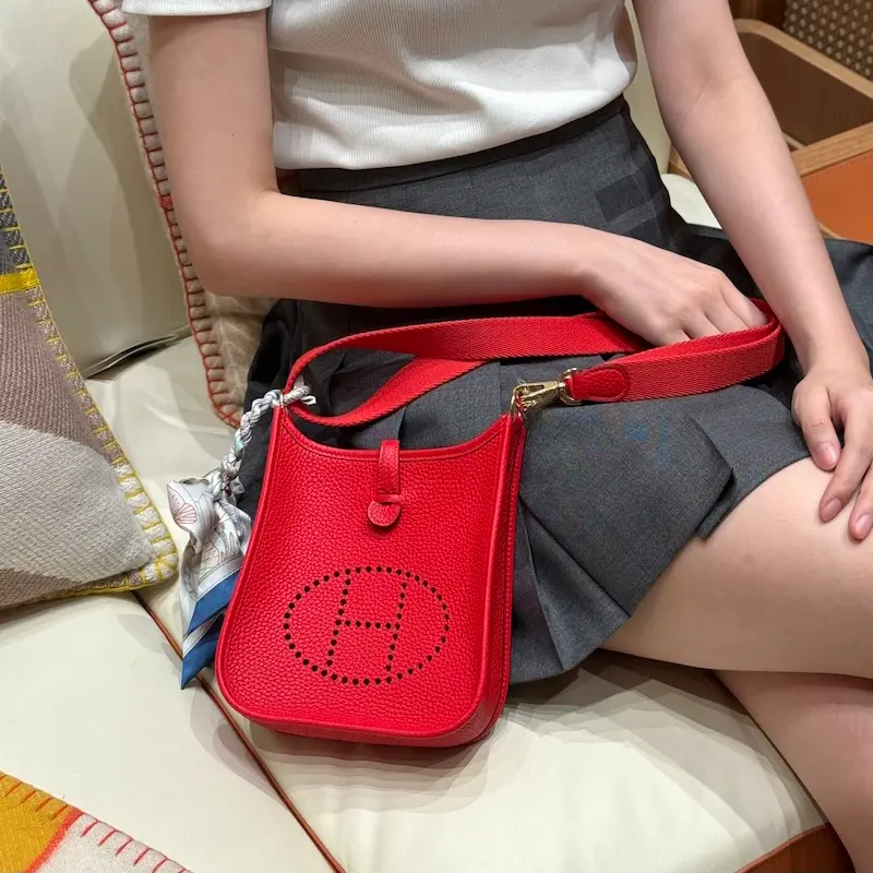 Vibrant red Hermes Evelyne TPM replica bag unboxing with orange box