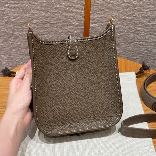 Back view showing exterior pocket on Etoupe Hermes Evelyne replica bag