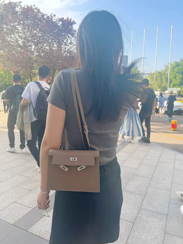 Detail Shot: Adjustable Strap on Replica Kelly Danse Bag Side view of Etoupe Grey Hermes Kelly Danse replica showing strap adjustment and leather texture