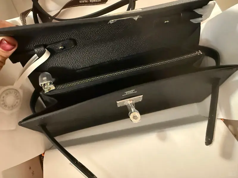 Interior view of replica Kelly wallet showing card slots and Hermes-style stamp