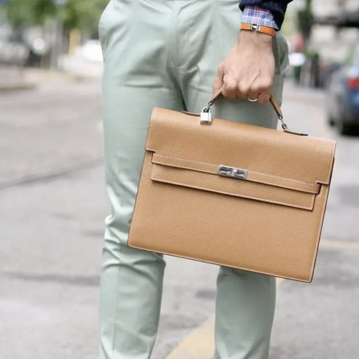 Woman carrying Replica Hermes Kelly Briefcase in Gold Brown calfskin leather