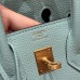Rear view of the best replica Hermes Blue Atoll Replica Handbag Store 25, showcasing the gold pocket and silver accent.
