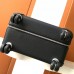 Close-up of the leather trim and metal rivets on the replica Hermes cabin suitcase.