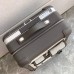 Close-up of the leather trim and metal rivets on the replica Hermes cabin suitcase.