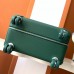 Close-up of the leather trim and metal rivets on the replica Hermes cabin suitcase.