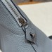 Detachable shoulder strap attachment on the black Togo leather replica Bolide.
