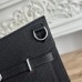 Flap closure with toggle mechanism on black Togo leather replica Jypsiere.